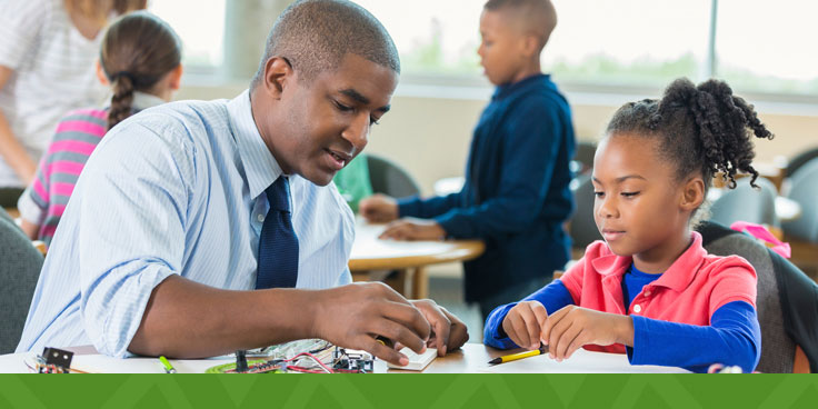 teacher working with a student